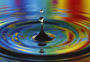 Ripples in rainbow water symbolizing psychic readings drawn from the collective consciousness