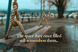 A gently moving empty swing in a quiet playground, symbolizing the absence and presence felt after losing a child.