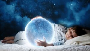 Child dreaming with a glowing ball of psychic energy