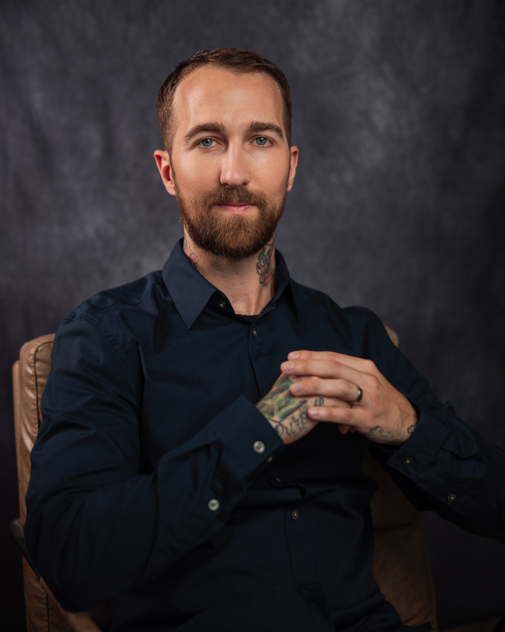 The-best-tarot-reader-in-the-world-Chris-Bennett-based-out-of-Vancouver-British-Columbia-Canada. Sitting in chair for a professional studio photo with Michael Aaron Keith photographer in Vancouver British Columbia