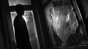 figure-standing-before-cracked-mirror-in-dim-room-with-half-reflection-lit-and-half-in-shadow-high-contrast-photo