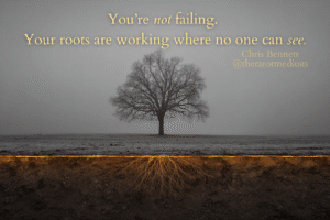 Bare winter tree with glowing roots beneath the earth symbolizing unseen growth, inner timing and emotional recalibration during burnout or life stagnation.