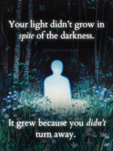 An illuminated human silhouette sitting in a lotus meditation pose beside a forest stream at night, surrounded by darkness with soft light glowing from within. The image includes the quote: “Your light didn’t grow in spite of the darkness. It grew because you didn’t turn away.”