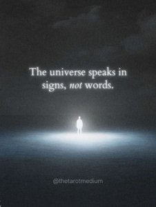 An illuminated human silhouette standing in a dark field at night with the quote “The universe speaks in signs, not words.”
